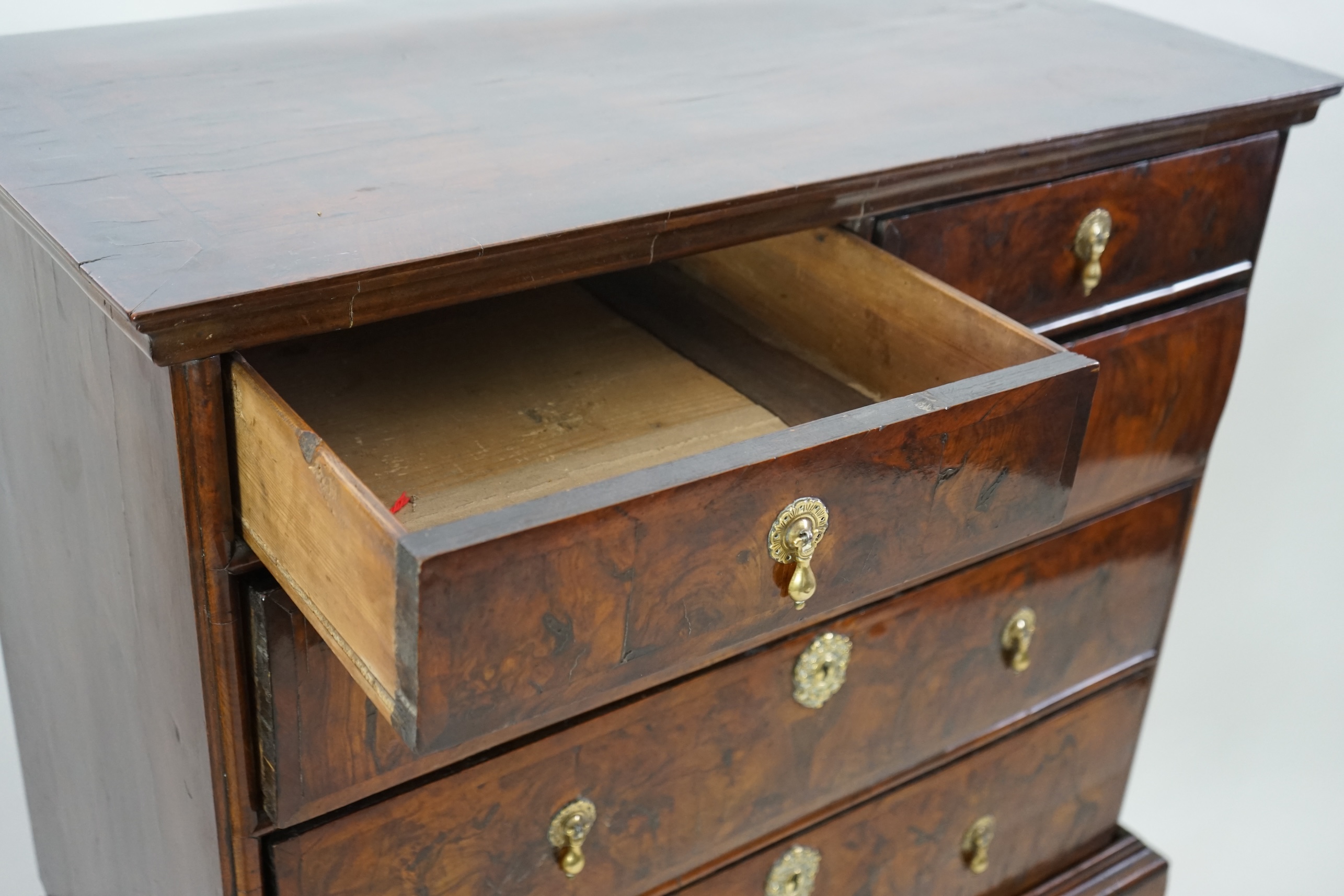 An early 18th century and later crossbanded walnut chest on stand